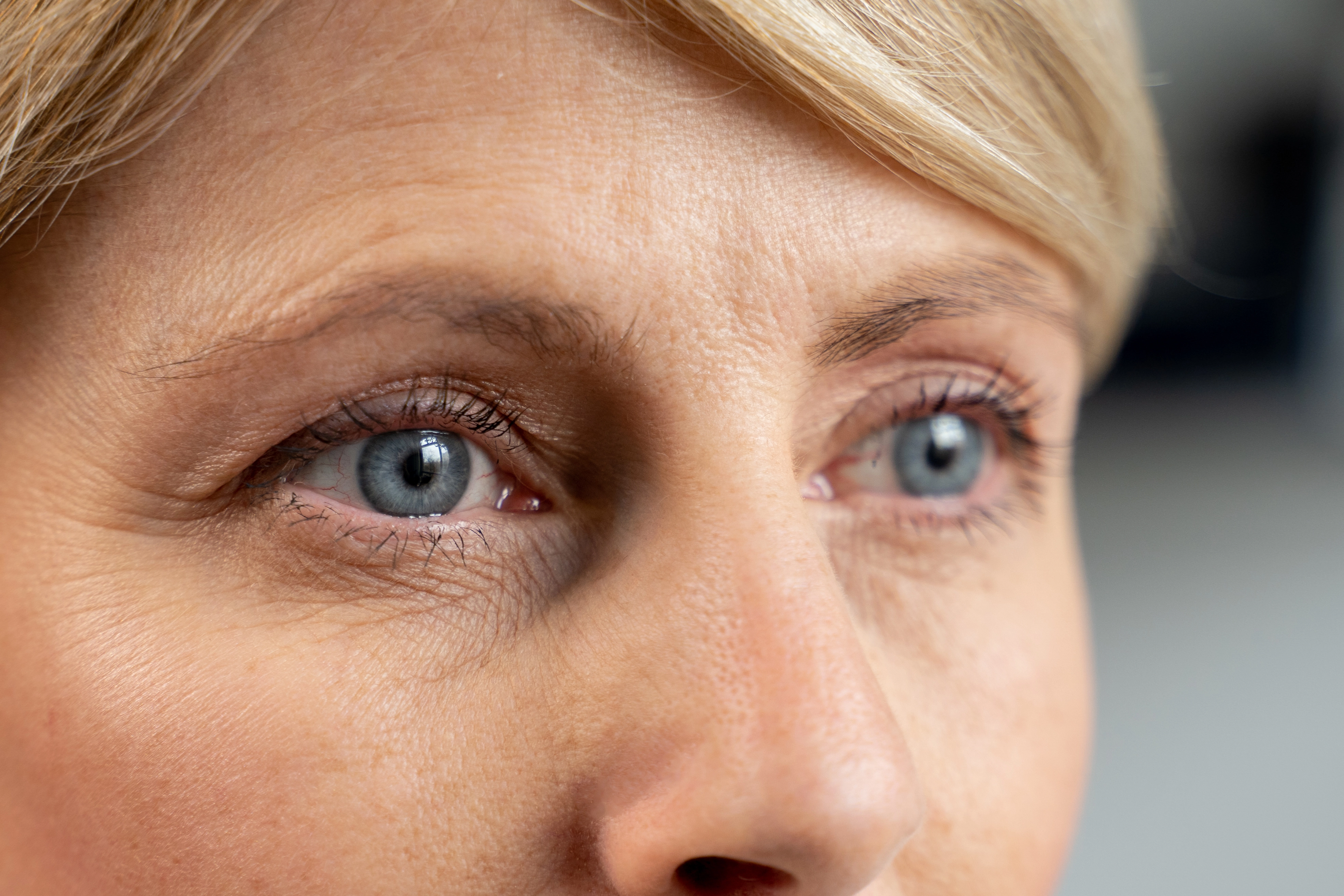 portrait-middleaged-woman-looks-into-distance-closeup-womans-blue-eyes-1-671659aa13559590034880.webp